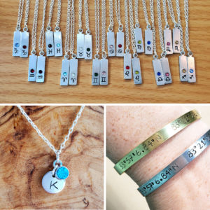 an assortment of handmade stamped metal jewelry